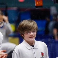 A competitor smiles with his coach during the 2026 GVSU West MI District Event